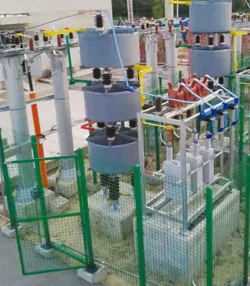 Outdoor HYTBB frame in a fenced yard, with reactors, capacitor racks, and phase leads